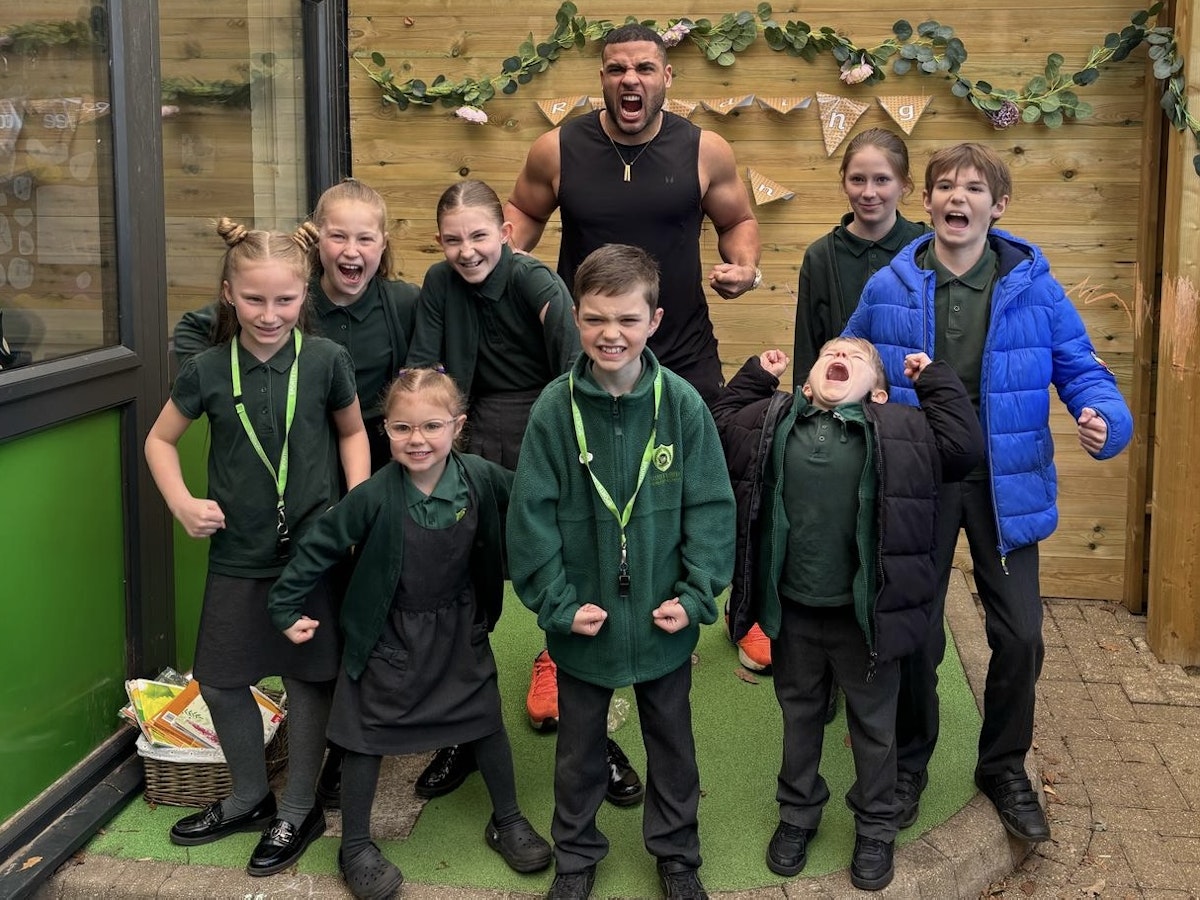 Gladiator Steel posing with students at Gusford Primary School